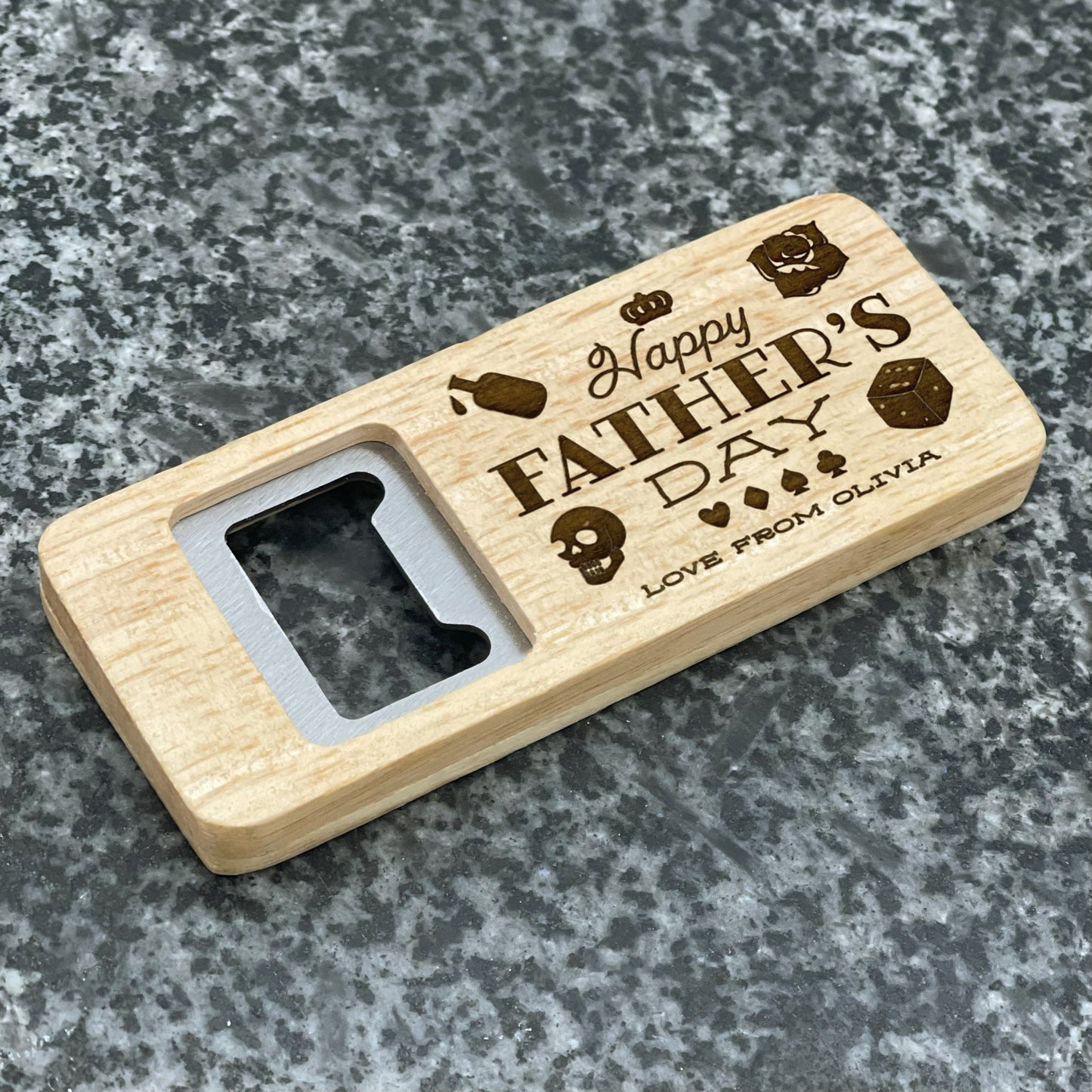 Father's Day Bottle Opener: Happy Father's Day. Pictured on a stone countertop.