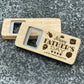 Father's Day Bottle Opener: Happy Father's Day. Pictured showing the engraved front and blank back, on a stone countertop