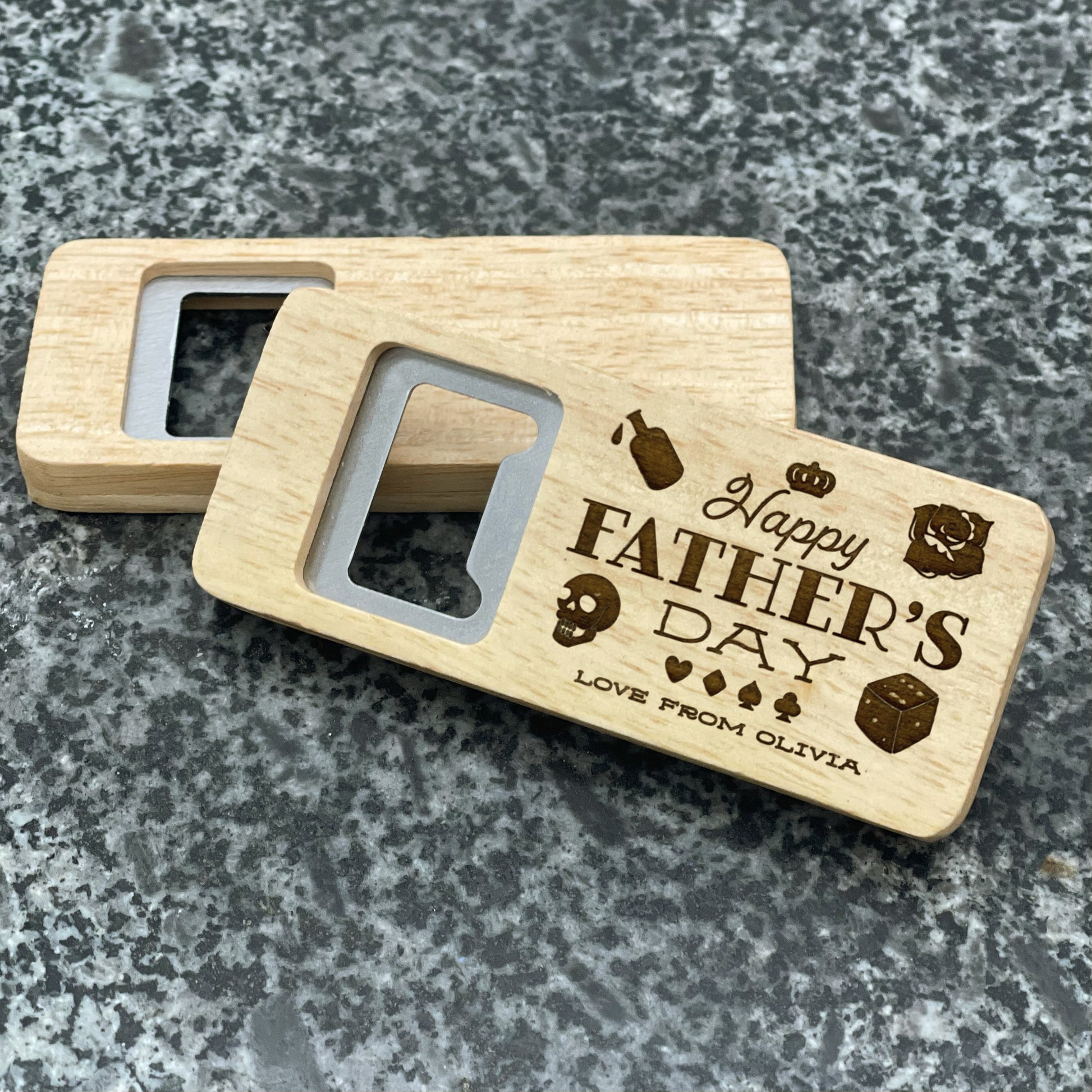 Father's Day Bottle Opener: Happy Father's Day. Pictured showing the engraved front and blank back, on a stone countertop